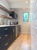 Modern home with Kitchen, Colorful Cabinet, Refrigerator, Ice Maker, Light Hardwood Floor, Microwave, Ceiling Lighting, Track Lighting, Engineered Quartz Counter, Range, Ceramic Tile Backsplashe, Dishwasher, and Undermount Sink. Fabulous kitchen Photo 5 of Modern Riverfront Townhouse in Aspen
