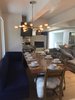 Modern home with Dining Room, Light Hardwood Floor, Ceiling Lighting, Wood Burning Fireplace, Bar, Stools, Chair, Bench, and Table. Plenty of seating Photo 6 of Modern Riverfront Townhouse in Aspen