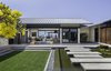 Modern home with Outdoor, Large Patio, Porch, Deck, Flowers, Grass, Front Yard, Stone Fences, Wall, Trees, Walkways, and Gardens. Entry Courtyard Photo 5 of Manini`owali 3