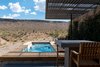 Modern home with Outdoor, Back Yard, Wood Patio, Porch, Deck, Wood Fences, Wall, Lap Pools, Tubs, Shower, Landscape Lighting, Desert, Field, Shrubs, Hardscapes, Hot Tub Pools, Tubs, Shower, and Decking Patio, Porch, Deck. Hoogland Architecture designed the Rubber Ducky Trail House to capture desert views from every angle. An outdoor spa allows the residents to linger outdoors well into the evening. Photo 2 of The Rubber Ducky Trail House