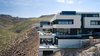 Modern home with Exterior, Flat RoofLine, House Building Type, Stucco Siding Material, Metal Roof Material, Metal Siding Material, Stone Siding Material, and Concrete Siding Material. Profile view Photo 2 of The Huhn House
