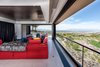 Modern home with Living Room, Ceiling Lighting, and Wall Lighting. Theater with pocket doors open. In use a black curtain automatically encloses the room for optimal viewing. Photo 12 of The Huhn House