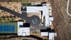 Modern home with Exterior, Flat RoofLine, Stone Siding Material, Concrete Siding Material, Metal Siding Material, Metal Roof Material, House Building Type, and Stucco Siding Material. Aerial view Photo of The Huhn House