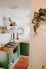 Modern home with Kitchen, Light Hardwood Floor, Wood Counter, Open Cabinet, Colorful Cabinet, Ceramic Tile Backsplashe, Cooktops, Drop In Sink, Porcelain Tile Backsplashe, Range, and Range Hood. A view from the hall looking down at the kitchen! Photo 6 of The Cougar