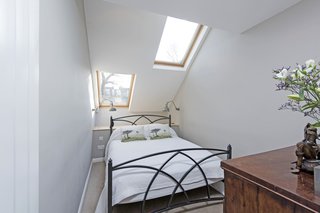 The master bedroom has a dressing room and an en-suite bathroom, giving it the feeling of a private suite.