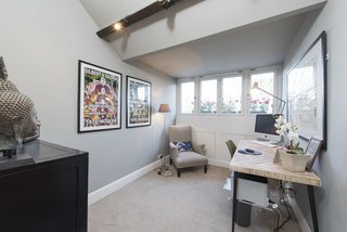 Four windows and a half-vaulted ceiling make a compact space feel spacious.