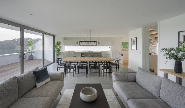 The living space in the open-plan kitchen/dining/living spaces flows out onto the south-facing terrace. The soft gray color scheme works with Cornwall's cool light and large skies.