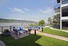 Modern home with Outdoor, Large Patio, Porch, Deck, Grass, Flowers, Horizontal Fences, Wall, Raised Planters, Rooftop, Wood Patio, Porch, Deck, Post Lighting, Back Yard, Walkways, and Metal Fences, Wall. 1177 @Greystone Sunset Deck Photo 4 of 1177 @Greystone