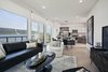 Modern home with Living Room, Coffee Tables, Ottomans, Sofa, Ceiling Lighting, End Tables, Console Tables, Laminate Floor, Table Lighting, and Chair. 1177 @Greystone Apartment with Hudson River and Palisades Views Photo 5 of 1177 @Greystone