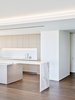Modern home with Kitchen, Marble Counter, Drop In Sink, Cooktops, Recessed Lighting, and Medium Hardwood Floor. The crisp white kitchen features appliances built into the cabinetry and marble countertops. Photo 6 of Private Residence 4