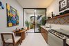 Modern home with Kitchen, Refrigerator, Wood Cabinet, Engineered Quartz Counter, Mosaic Tile Backsplashe, and Concrete Floor. Kitchen Photo 10 of Casa Picasso