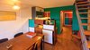 Modern home with Kitchen, White Cabinet, Colorful Cabinet, Metal Counter, Tile Counter, Wood Counter, Medium Hardwood Floor, Refrigerator, Cooktops, Wood Cabinet, Drop In Sink, Range, Accent Lighting, Metal Backsplashe, and Wall Lighting. Original Kitchen Buffet by Charlotte Perriand from 1952, Marseille Photo 3 of Corbusier Re-Renovation Berlin