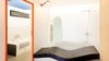 Modern home with Bath Room, Ceiling Lighting, Freestanding Tub, Medium Hardwood Floor, Ceramic Tile Wall, Ceramic Tile Floor, Full Shower, Mosaic Tile Wall, Wall Mount Sink, Open Shower, Wall Lighting, and One Piece Toilet. Bathroom, Bath tub 1958, Shower 2017 Photo 14 of Corbusier Re-Renovation Berlin