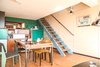 Modern home with Living Room, Chair, Bookcase, Wall Lighting, Accent Lighting, and Medium Hardwood Floor. Living room and stair Photo of Corbusier Re-Renovation Berlin