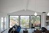 Modern home with Living Room, Corner Fireplace, Pendant Lighting, Light Hardwood Floor, Ceiling Lighting, Chair, Coffee Tables, and Sofa. Natural light and expansive views are abundant in the living space. Photo 9 of Raber By VEIN