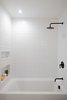 Modern home with Ceiling Lighting. Each bathroom features matte black hardware and oversized Phylrich rain shower heads. Photo 14 of Raber By VEIN