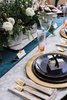 Modern home with Dining Room and Table. Shop Wisely
Always purchase décor items that can be reused and recycled for different occasions. The blue CB2 plates were a perfect find for a galaxy-inspired look, but they could also be reused for an elegant baby-shower or engagement party. The throw pillows and area rug speak to our deep navy blue tones, but with a little tweaking and fresh flowers, these items would also showcase beautifully in a spring décor scheme. By investing on your splurge on items that can be used over and over again, and shopping wisely for items that are very specific and seasonal only, you can feel great about all your holiday purchases this season. Photo 6 of A Mosaic Modern Holiday at Victoria with Karin Bohn