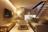 Modern home with Living Room, Wall Lighting, Coffee Tables, Chair, Light Hardwood Floor, Table Lighting, Sofa, Floor Lighting, Bench, and Medium Hardwood Floor. round room Photo of My Kyoto Town House