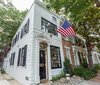 Modern home with Exterior, Brick Siding Material, Green Roof Material, Stone Siding Material, Flat RoofLine, and House Building Type. 1900 Brick Federal (Front facade) Photo of The Yacht House