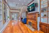 Modern home with Living Room, Medium Hardwood Floor, Recessed Lighting, Ceiling Lighting, Sofa, and Gas Burning Fireplace. Living room features fully-customed bookshelves and fireplace plus mahogany wide plank floor Photo 2 of The Yacht House