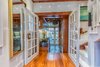 Modern home with Living Room, Ceiling Lighting, Medium Hardwood Floor, and Bookcase. Living room to kitchen (Oak French doors with nautically-inspired cleat handles) Photo 3 of The Yacht House