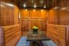 Modern home with Kitchen, Wall Lighting, Refrigerator, Quartzite Counter, Cooktops, Pendant Lighting, Wood Cabinet, Ceiling Lighting, Drop In Sink, Recessed Lighting, and Range. Fully-customed dinette seating in kitchen (raised mahogany paneling) Photo 5 of The Yacht House
