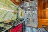 Modern home with Kitchen, Ceiling Lighting, Range, Pendant Lighting, Wall Lighting, Medium Hardwood Floor, Cooktops, Wood Cabinet, Drop In Sink, Refrigerator, Granite Counter, and Recessed Lighting. Premium AGA stove/range with 5 others and custom two toned color scheme Photo 6 of The Yacht House
