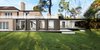 Modern home with Exterior, Brick Siding Material, House Building Type, Flat RoofLine, Metal Siding Material, Glass Siding Material, Metal Roof Material, Green Roof Material, and Wood Siding Material. The view of the side extension on the Art Atelier side Photo of Home & Art studio for Mrs L