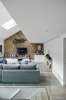Modern home with Living Room, Console Tables, Track Lighting, Sofa, Recessed Lighting, Accent Lighting, Ceiling Lighting, Coffee Tables, End Tables, and Light Hardwood Floor. The front view of the Living areas from the Dining Photo 7 of Olympia Loft