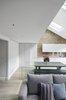 Modern home with Dining Room, Accent Lighting, Recessed Lighting, Track Lighting, Bench, Table, Chair, Ceiling Lighting, and Light Hardwood Floor. The Kitchen with its linear layout that maximizes the depth of the adjacent Dining area Photo 8 of Olympia Loft