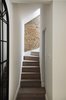 Modern home with Staircase and Wood Tread. The internal spirally-shaped staircase wrapping around the two bathrooms leads to the Master bedroom ensuite at the upper level Photo 10 of Olympia Loft