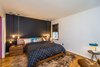 Modern home with Bedroom, Light Hardwood Floor, Bed, Wardrobe, Chair, Ceiling Lighting, Night Stands, and Pendant Lighting. Cloud-like comfort right at home. Live smart in the black and white bedroom with corner windows, solid walnut bed and queen size mattress. Photo 9 of Wren's Nest