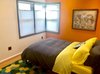 Modern home with Bedroom, Night Stands, Wardrobe, Bed, and Light Hardwood Floor. Enjoy the same undeniable view of the tranquil backyard. Photo 13 of Wren's Nest