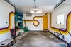 Retro painted 1 car garage features a heater for winter months with easy access to the basement refrigerator, laundry and utility room. Photo 15 of Wren's Nest modern home