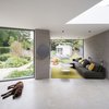 Modern home with Living Room, Console Tables, Recessed Lighting, and Concrete Floor. The new garden studio, seen through the window, is positioned at the point where the garden pivots off to a previously disconnected end of the outdoor space. Photo 2 of Oatlands