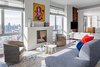 Modern home with Living Room, Sofa, Chair, End Tables, Medium Hardwood Floor, and Standard Layout Fireplace. Our client wanted to center their living room around an original piece from the Cuban artist Jose Rodriguez Fuster, one of the Caribbean’s most acclaimed living artists. So we sourced a menagerie of orange table objects and pillows to compliment the predominant colors in Fuster’s painting. To frame the formal area, we sourced two chairs from South Hill Home. Photo of Central Park West Penthouse