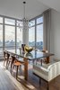 Modern home with Dining Room, Chair, Medium Hardwood Floor, Table, Ceiling Lighting, and Bench. We sourced a duet of custom-fabricated benches, with fabric from Donghia, and a lighting fixture from a local artisan. Photo 6 of Central Park West Penthouse