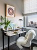 Modern home with Office, Chair, Study Room Type, Desk, and Dark Hardwood Floor. In curating a space that could serve as the couple’s home base, they asked for our help in reconciling the modern silhouettes of the apartment with the couple’s international art collection, which includes vibrant paintings from Latin America and Africa. Photo 9 of Central Park West Penthouse