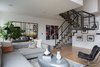 Modern home with Living Room, Chair, Light Hardwood Floor, Coffee Tables, and Sectional. We also sourced two Panton Chairs, from Design Within Reach. An area rug from Tom Dixon’s collection for The Rug Company adds a sophisticated, urban edge to the design. The staircase, which is prominently positioned in the center of the living area, featured iron railings, so we created continuity by refinishing the fireplace in iron and cement. Photo 3 of Renovated SoHo Duplex