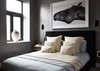 Modern home with Bedroom, Bed, Night Stands, and Wall Lighting. The couple wanted to give the space a modern, loft-like feeling. So, we added an internal window in the upstairs bedroom that overlooks the downstairs space, which lets in sunlight that floods through the double-height window in the living area. Still, they wanted to retain a moody vibe, so we used a grey textured wall covering throughout. Photo 8 of Renovated SoHo Duplex