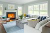 Modern home with Living Room, Ottomans, Sofa, Chair, Standard Layout Fireplace, and Medium Hardwood Floor. Colorful accent pillows and decorative geometric objects were added throughout the home, to further distinguish each room, and to offset the tasteful, neutral palette. Photo 7 of Contemporary Westchester Home
