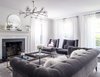 Modern home with Living Room, Coffee Tables, Dark Hardwood Floor, Chair, Sofa, Ceiling Lighting, and Standard Layout Fireplace. Going into this project, our client’s major motivation in seeking an interior designer was for them to feel welcome at home in what was an otherwise cold and lifeless, albeit light-filled home. Photo of Revitalized Old Greenwich Home