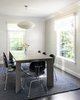 Modern home with Dining Room, Pendant Lighting, Dark Hardwood Floor, Table, and Chair. By keeping the dining room pared down and simple in appeal, the family can use the space as a multi-purpose meeting room for home-cooked dinners, entertaining, and for extra desk and project space when needed. Photo 5 of Revitalized Old Greenwich Home
