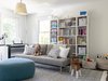 Modern home with Kids Room, Bench, Bookcase, Living Room Room Type, Pre-Teen Age, Storage, Shelves, Toddler Age, Neutral Gender, Dark Hardwood Floor, Night Stands, Playroom Room Type, Den Room Type, and Chair. In the kid’s playroom, Urszula placed importance on easy to manage organization by taking full advantage of a massive bookshelf while utilizing their toys, books, and games as styling objects to fill the unit with charming décor. Photo 9 of Revitalized Old Greenwich Home