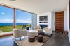 Modern home with Living Room, Gas Burning Fireplace, Concrete Floor, Chair, and Ceiling Lighting. Ohana Living Room Photo 2 of QK Haiku
