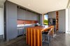 Modern home with Kitchen, Cooktops, Refrigerator, Granite Counter, Wood Cabinet, Beverage Center, Microwave, Undermount Sink, Recessed Lighting, Ice Maker, Dishwasher, Ceiling Lighting, Accent Lighting, and Concrete Floor. Ohana Kitchen Photo 3 of QK Haiku