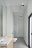 Modern home with Bath Room, Wood Counter, Ceramic Tile Floor, Pendant Lighting, Ceramic Tile Wall, Open Shower, Enclosed Shower, Vessel Sink, Full Shower, and One Piece Toilet. The bathroom features clean, modern finishes. Photo 10 of La Binocle