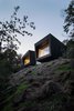 Modern home with Exterior, Metal Roof Material, Wood Siding Material, Shed RoofLine, House Building Type, and Cabin Building Type. “At night, the chalet is transformed. When it is dark, the mirror effect of the reflection of the interior space in the windows completely changes the cabin’s relationship to its site and makes it appear larger,” adds Rasselet. Photo 3 of La Binocle