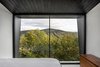 Modern home with Bedroom, Bed, Ceramic Tile Floor, and Dresser. Floor-to-ceiling windows fill this bedroom with natural light. Photo 9 of La Binocle