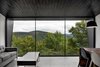 Modern home with Living Room, Ceramic Tile Floor, Sofa, Pendant Lighting, Coffee Tables, Chair, and Table. The living room provides sweeping views of mountain vistas. Photo 8 of La Binocle